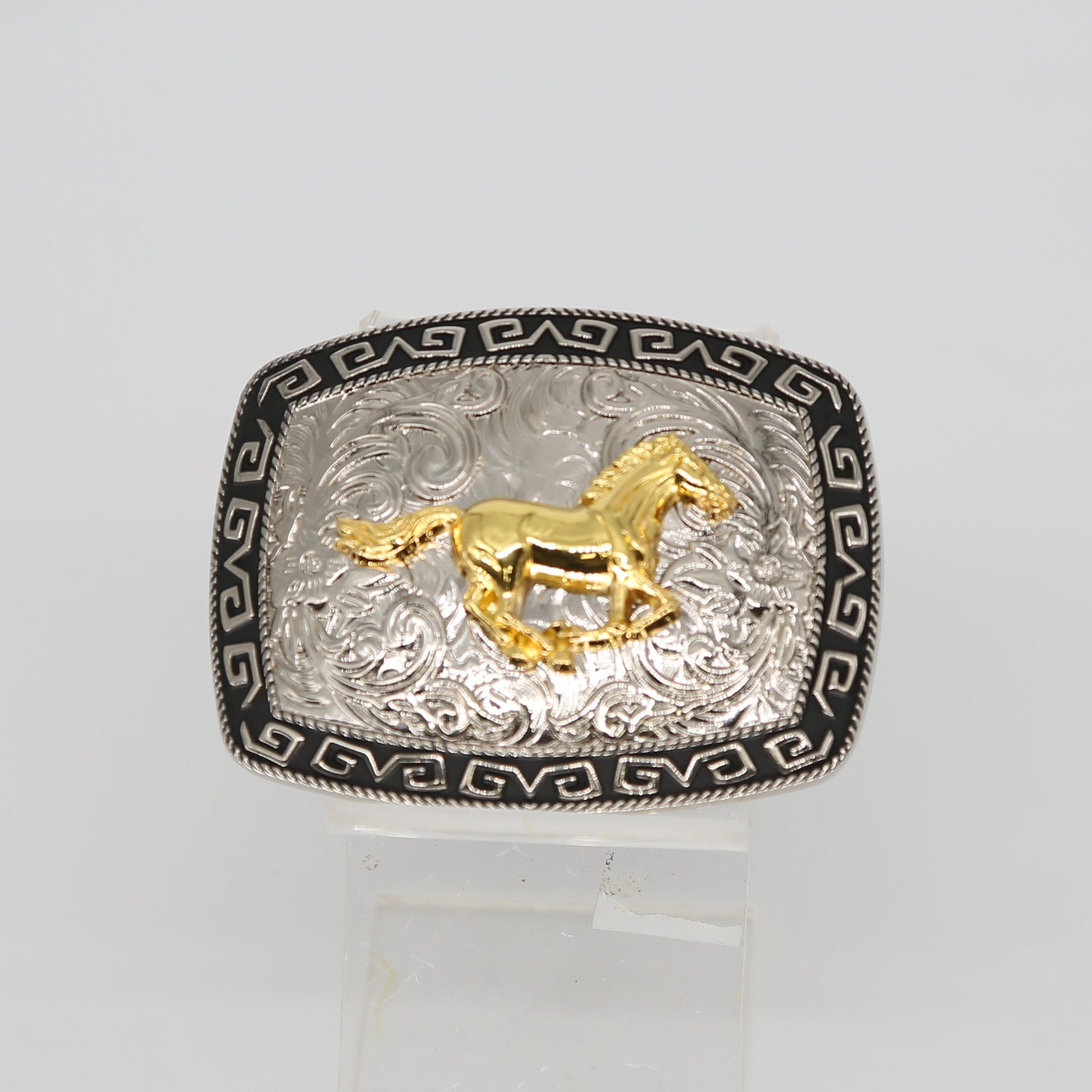 Silver ring with gold horse design on a white background